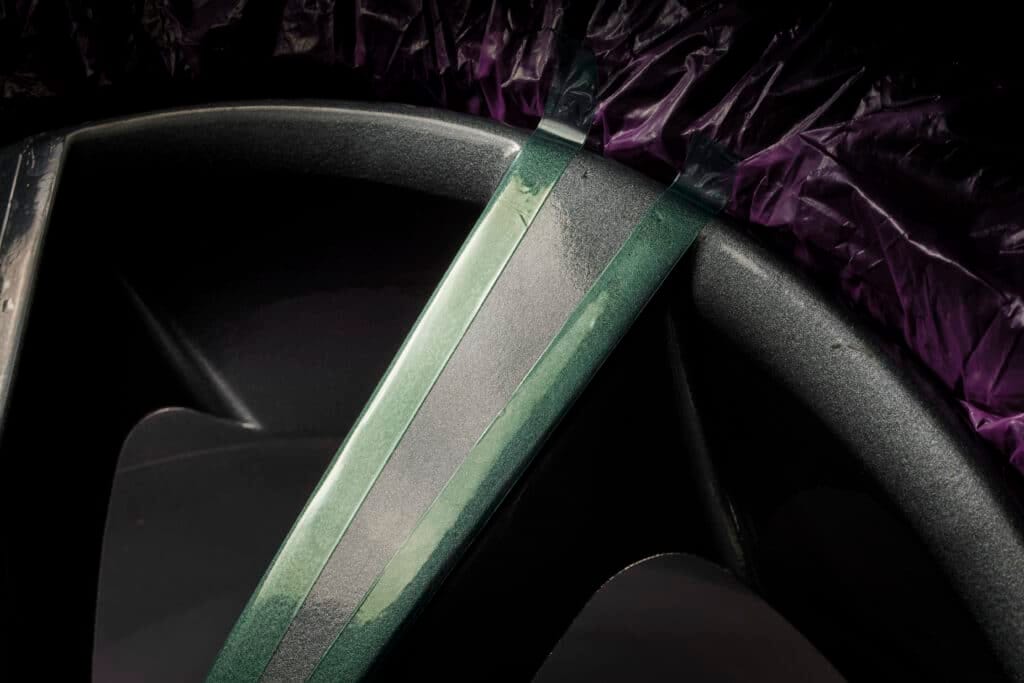 A close up photo of a car wheel with the tyre having JTAPE'S "Wheel Repair Mask" wrapped around it