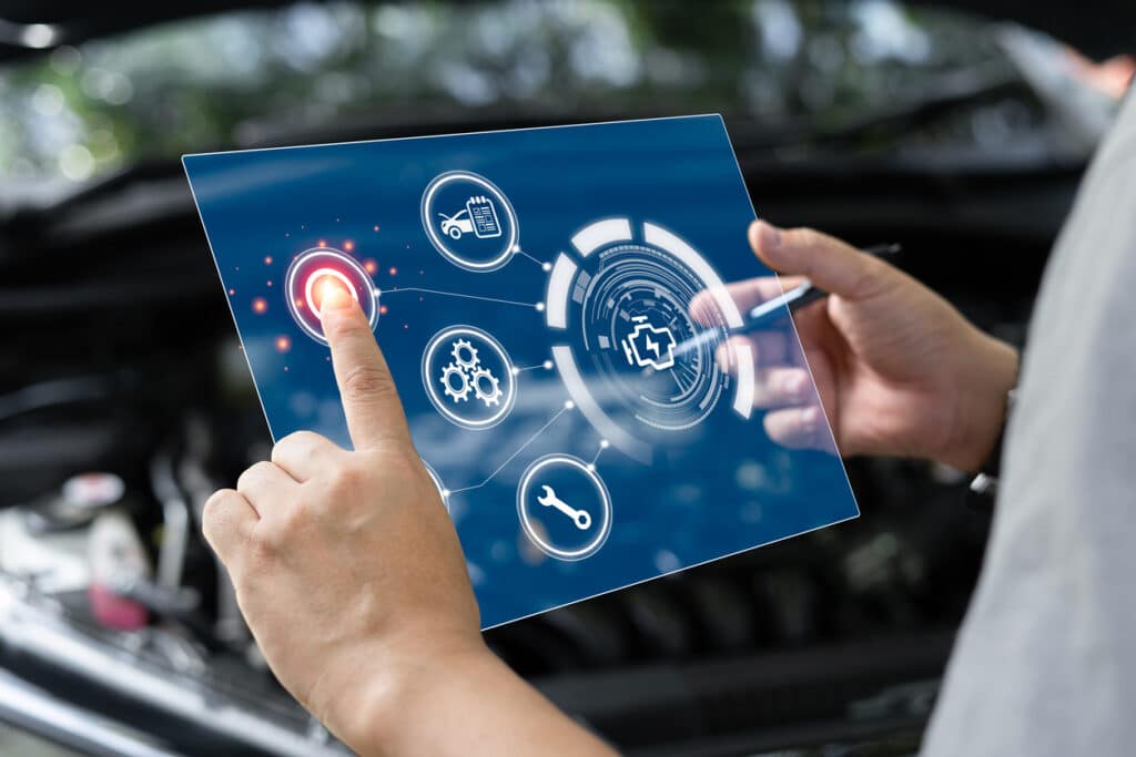 technician looking at car statistics on digital screen